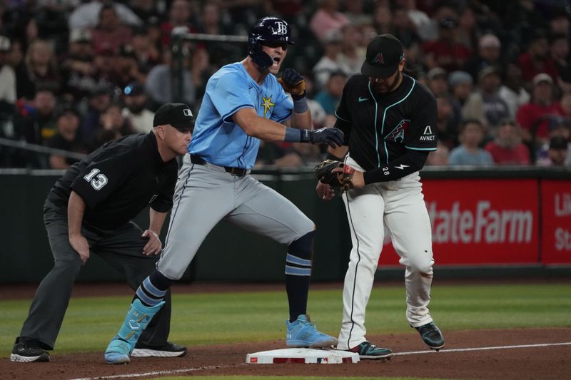 Apr 23, 2025; Phoenix, Arizona, USA; Tampa Bay Rays outfielder Kameron Misner (26) reacts after hitting an RBI triple against the Arizona Diamondbacks during the eleventh inning at Chase Field. Mandatory Credit: Rick Scuteri-Imagn Images