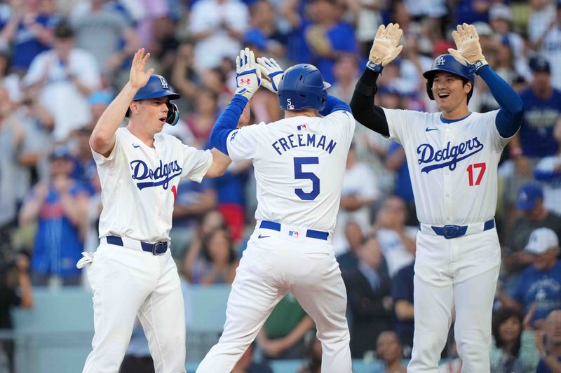 Jul 3, 2024; Los Angeles, California, USA; Los Angeles Dodgers first baseman Freddie Freeman (5) celebrates with catcher Will Smith (16) and designated hitter Shohei Ohtani (17) after hitting a three-run home run in the first inning against the Arizona Diamondbacks at Dodger Stadium. Mandatory Credit: Kirby Lee-USA TODAY Sports