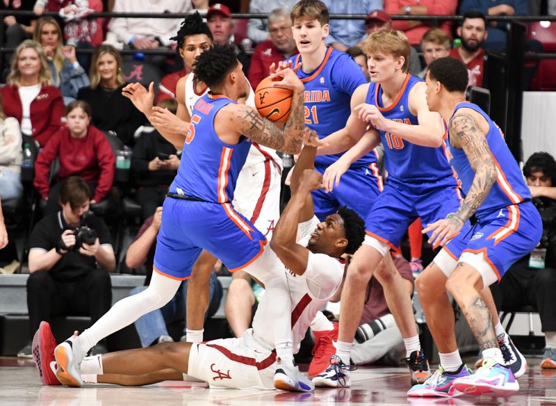 Feb 21, 2024; Tuscaloosa, Alabama, USA;  Alabama Crimson Tide forward Mouhamed Dioubate (10) and Florida Gators guard Will Richard (5) fight for the ball at Coleman Coliseum. Mandatory Credit: Gary Cosby Jr.-USA TODAY Sports