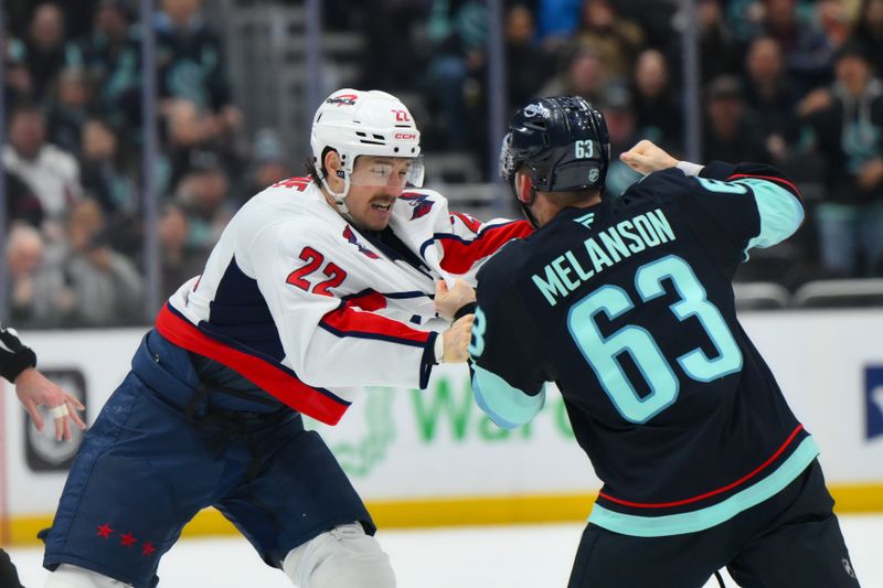 Jan 27, 2026; Seattle, Washington, USA; Washington Capitals right wing Brandon Duhaime (22) and Seattle Kraken right wing Jacob Melanson (63) fight during the third period at Climate Pledge Arena. Mandatory Credit: Steven Bisig-Imagn Images