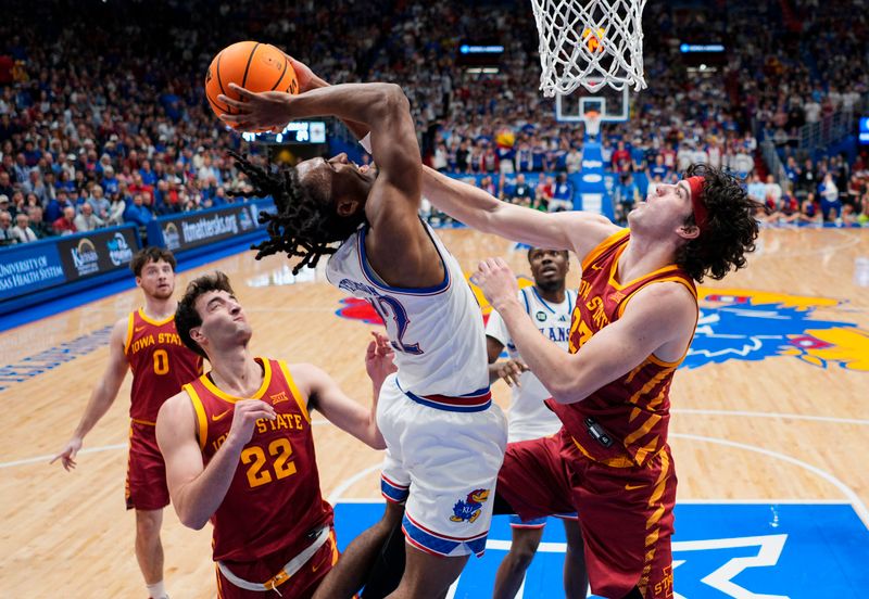 Jan 13, 2026; Lawrence, Kansas, USA; Kansas Jayhawks guard Darryn Peterson (22) shoots against Iowa State Cyclones forward Blake Buchanan (23) during the second half at Allen Fieldhouse. Mandatory Credit: Jay Biggerstaff-Imagn Images