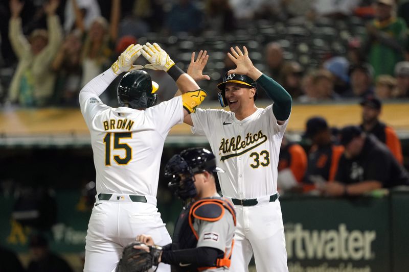 Sep 6, 2024; Oakland, California, USA; Oakland Athletics left fielder Seth Brown (15) celebrates with center fielder JJ Bleday (33) after hitting a home run against the Detroit Tigers during the eleventh inning at Oakland-Alameda County Coliseum. Mandatory Credit: Darren Yamashita-Imagn Images