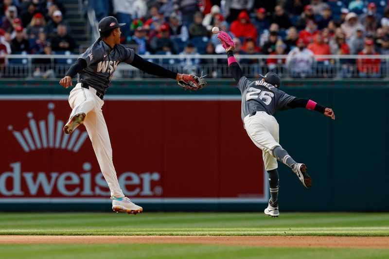 Apr 6, 2024; Washington, District of Columbia, USA; Washington Nationals outfielder Jesse Winker (6) attempts to catch a line drive hit by Philadelphia Phillies second baseman Bryson Stott (not pictured) as Nationals third baseman Trey Lipscomb (38) looks on during the seventh inning at Nationals Park. Mandatory Credit: Geoff Burke-USA TODAY Sports