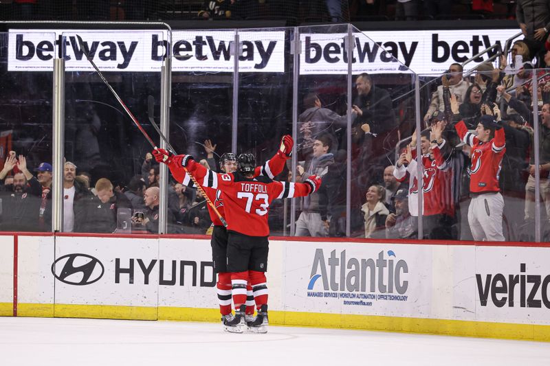 Jan 22, 2024; Newark, New Jersey, USA; New Jersey Devils right wing Tyler Toffoli (73) celebrates his game-winning goal in overtime against the Vegas Golden Knights with defenseman Luke Hughes (43) at Prudential Center. Mandatory Credit: Vincent Carchietta-USA TODAY Sports