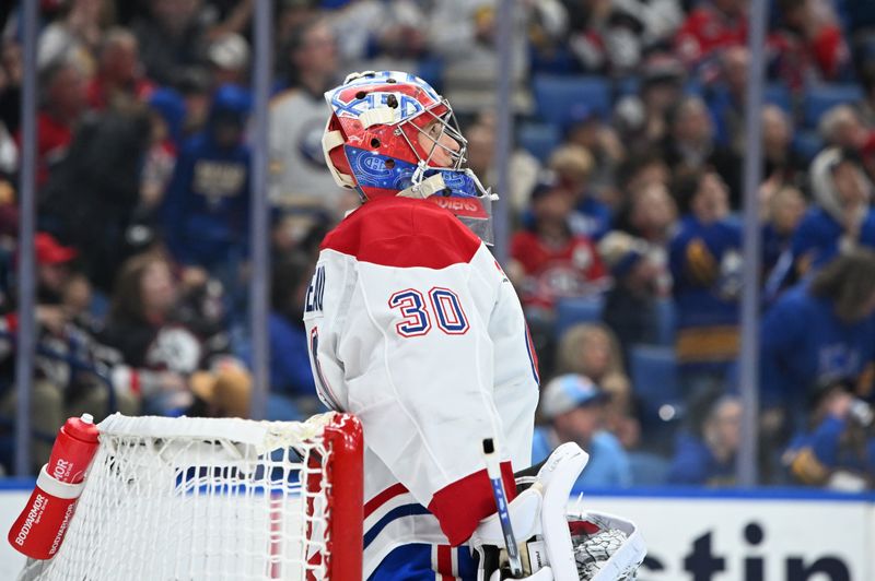 Nov 11, 2024; Buffalo, New York, USA; Montreal Canadiens goaltender Cayden Primeau (30) looks to the scoreboard in the second period against the Buffalo Sabres at KeyBank Center. Mandatory Credit: Mark Konezny-Imagn Images