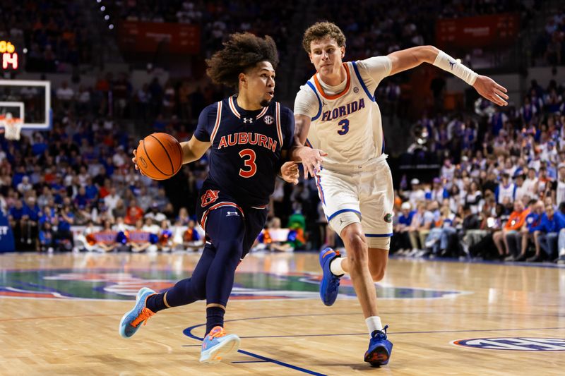 Feb 10, 2024; Gainesville, Florida, USA; Auburn Tigers guard Tre Donaldson (3) drives to the basket against Florida Gators center Micah Handlogten (3) during the first half at Exactech Arena at the Stephen C. O'Connell Center. Mandatory Credit: Matt Pendleton-USA TODAY Sports