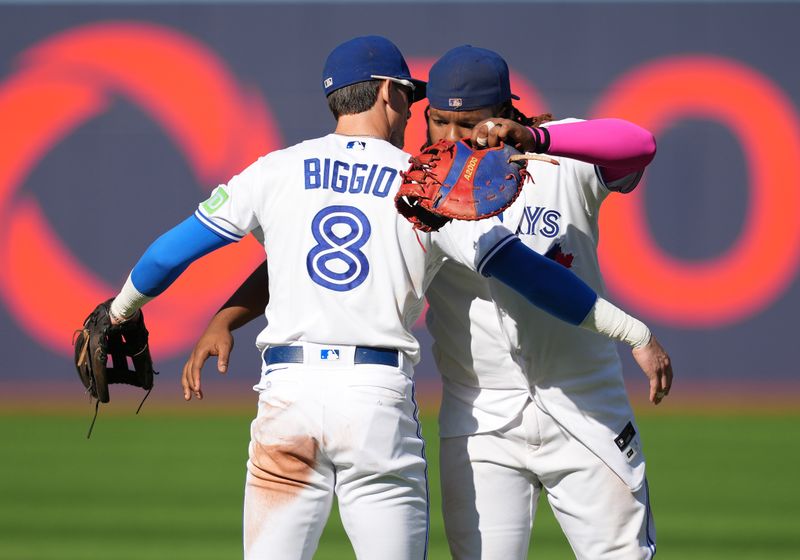 Sep 10, 2023; Toronto, Ontario, CAN; Toronto Blue Jays first baseman Vladimir Guerrero Jr., right, and pinch hitter Cavan Biggio (8) celebrate the win against the Kansas City Royals at the end of the ninth inning at Rogers Centre. Mandatory Credit: Nick Turchiaro-USA TODAY Sports