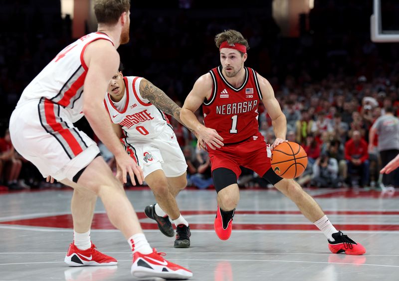 Jan 5, 2026; Columbus, Ohio, USA;  Nebraska Cornhuskers guard Sam Hoiberg (1) drives to the basket as Ohio State Buckeyes guard John Mobley Jr. (0) defends during the first half at Value City Arena. Mandatory Credit: Joseph Maiorana-Imagn Images