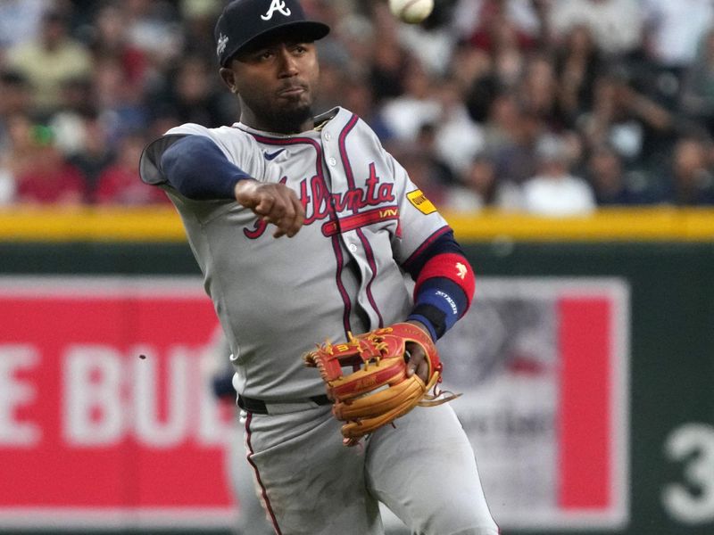 Apr 25, 2025; Phoenix, Arizona, USA; Atlanta Braves second base Ozzie Albies (1) makes the off balance throw for an out against the Arizona Diamondbacks in the first inning at Chase Field. Mandatory Credit: Rick Scuteri-Imagn Images