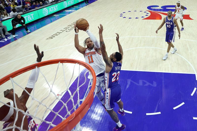 PHILADELPHIA, PENNSYLVANIA - APRIL 25: Jalen Brunson #11 of the New York Knicks shoots over Cameron Payne #22 of the Philadelphia 76ers during the fourth quarter of game three of the Eastern Conference First Round Playoffs at the Wells Fargo Center on April 25, 2024 in Philadelphia, Pennsylvania. NOTE TO USER: User expressly acknowledges and agrees that, by downloading and/or using this Photograph, user is consenting to the terms and conditions of the Getty Images License Agreement. (Photo by Tim Nwachukwu/Getty Images)