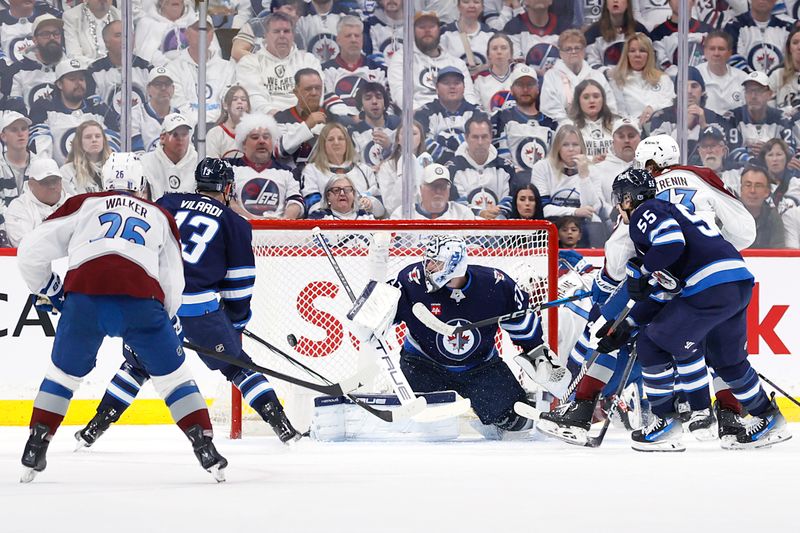 Apr 30, 2024; Winnipeg, Manitoba, CAN; Colorado Avalanche center Yakov Trenin (73) scores on Winnipeg Jets goaltender Connor Hellebuyck (37) in the second period in game five of the first round of the 2024 Stanley Cup Playoffs at Canada Life Centre. Mandatory Credit: James Carey Lauder-USA TODAY Sports