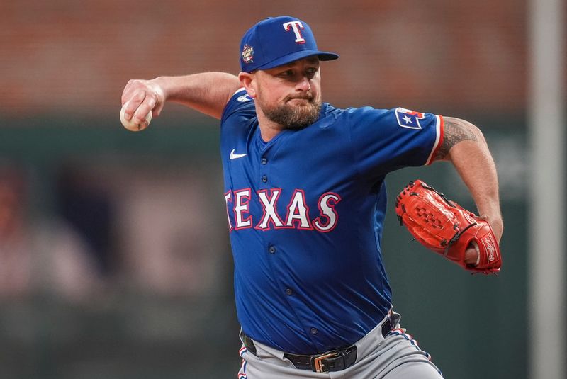 Apr 21, 2024; Cumberland, Georgia, USA; Texas Rangers relief pitcher Kirby Yates (39) pitches against the Atlanta Braves during the ninth inning at Truist Park. Mandatory Credit: Dale Zanine-USA TODAY Sports