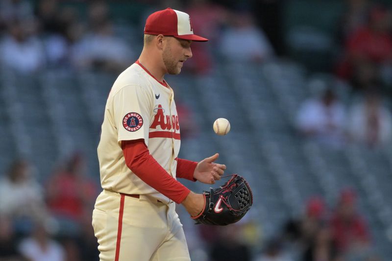 Sep 16, 2024; Anaheim, California, USA;  Los Angeles Angels starting pitcher Reid Detmers (48) tosses the ball after giving up a home run in the first inning against the Chicago White Sox at Angel Stadium. Mandatory Credit: Jayne Kamin-Oncea-Imagn Images