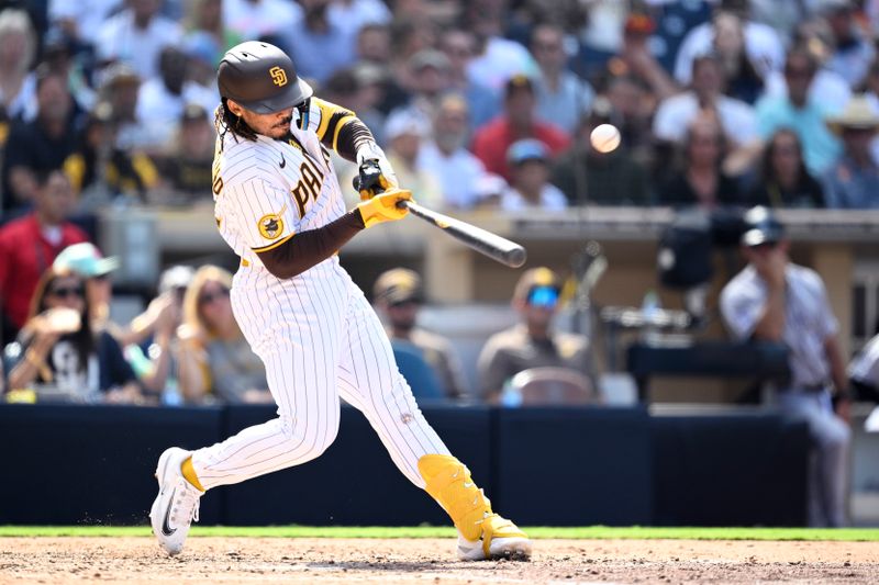 Sep 20, 2023; San Diego, California, USA; San Diego Padres pinch hitter Luis Campusano (12) hits an RBI single against the Colorado Rockies during the seventh inning at Petco Park. Mandatory Credit: Orlando Ramirez-USA TODAY Sports