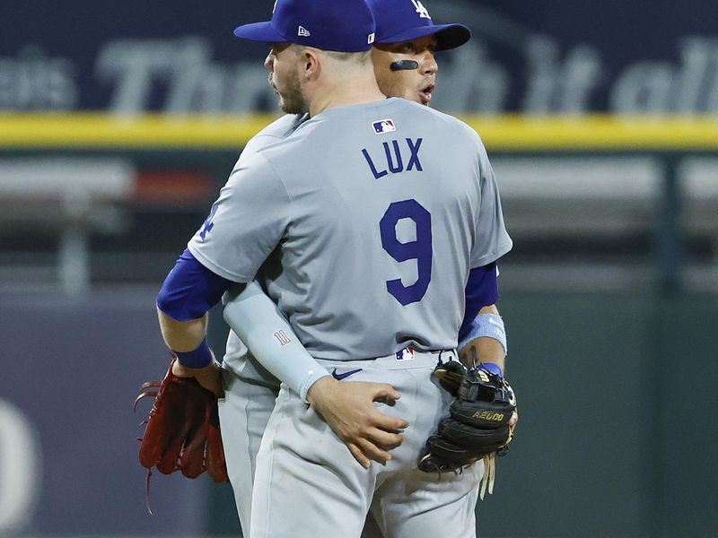 Jun 25, 2024; Chicago, Illinois, USA; Los Angeles Dodgers second baseman Gavin Lux (9) celebrates the win with shortstop Miguel Rojas (11) against the Chicago White Sox at Guaranteed Rate Field. Mandatory Credit: Kamil Krzaczynski-USA TODAY Sports