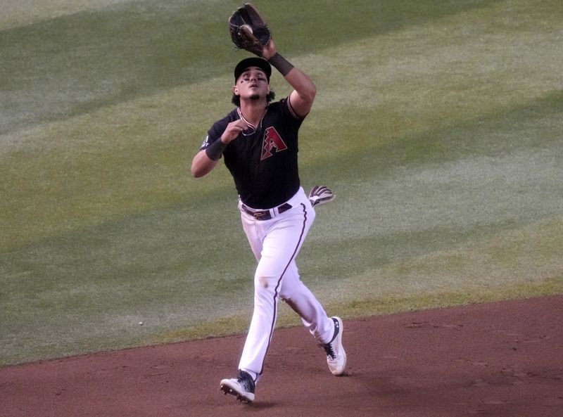 Jun 17, 2023; Phoenix, Arizona, USA; Arizona Diamondbacks infielder Josh Rojas (10) catches a pop fly against the Cleveland Guardians at Chase Field. Mandatory Credit: Joe Rondone-USA TODAY Sports