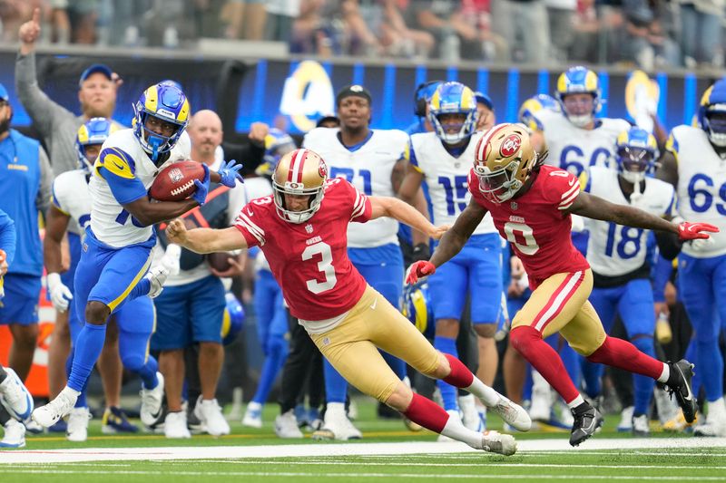 Los Angeles Rams' Xavier Smith, left, returns a punt past San Francisco 49ers punter Mitch Wishnowsky (3) and Renardo Green (0) during the second half of an NFL football game, Sunday, Sept. 22, 2024, in Inglewood, Calif. (AP Photo/Ashley Landis)