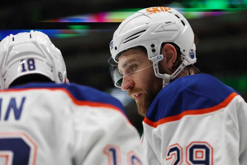 Oct 19, 2024; Dallas, Texas, USA; Edmonton Oilers center Leon Draisaitl (29) talks to left wing Zach Hyman (18) in the second period against the Dallas Stars at American Airlines Center. Mandatory Credit: Tim Heitman-Imagn Images