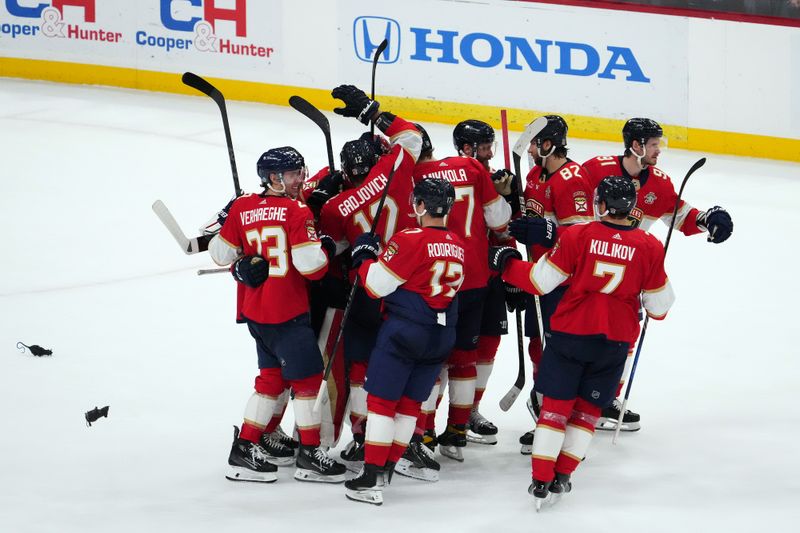 Jan 11, 2024; Sunrise, Florida, USA; Florida Panthers teammates celebrate after defeating the Los Angeles Kings in overtime at Amerant Bank Arena. Mandatory Credit: Jasen Vinlove-USA TODAY Sports