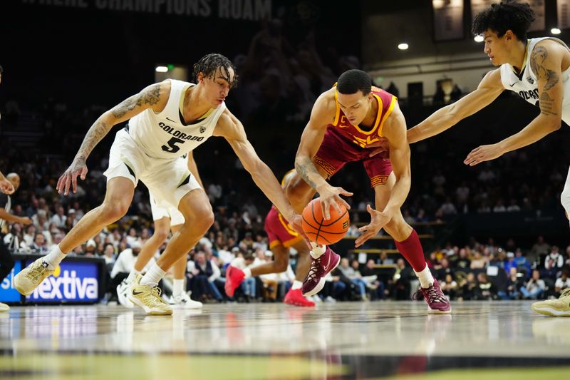 Feb 23, 2023; Boulder, Colorado, USA; Colorado Buffaloes guard Quincy Allen (5) knocks the ball away from USC Trojans forward Kobe Johnson (0) in the second half at the CU Events Center. Mandatory Credit: Ron Chenoy-USA TODAY Sports