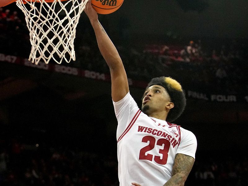 Feb 13, 2024; Madison, Wisconsin, USA;. Wisconsin guard Chucky Hepburn (23) scores after a steal during the second half of their game at the Kohl Center. Mandatory Credit: Mark Hoffman/Milwaukee Journal Sentinelf-USA TODAY Sports
