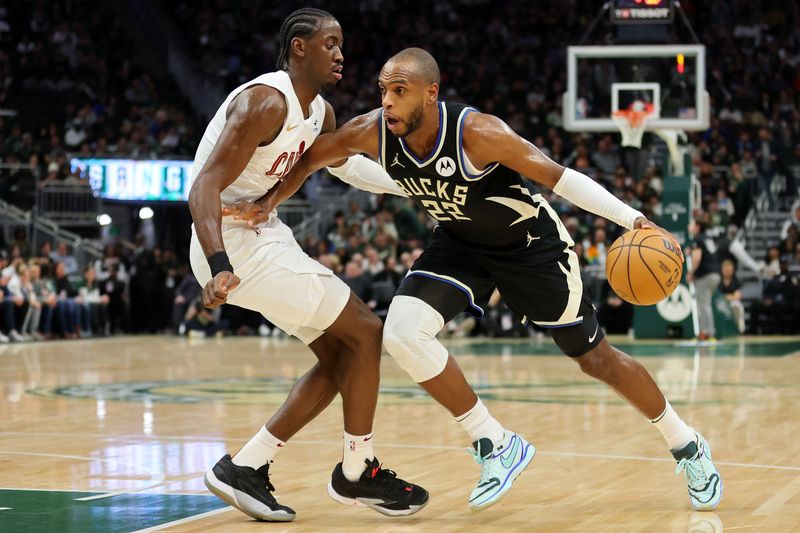 MILWAUKEE, WISCONSIN - JANUARY 26: Khris Middleton #22 of the Milwaukee Bucks is defended by Caris LeVert #3 of the Cleveland Cavaliers during a game at Fiserv Forum on January 26, 2024 in Milwaukee, Wisconsin. NOTE TO USER: User expressly acknowledges and agrees that, by downloading and or using this photograph, User is consenting to the terms and conditions of the Getty Images License Agreement. (Photo by Stacy Revere/Getty Images)