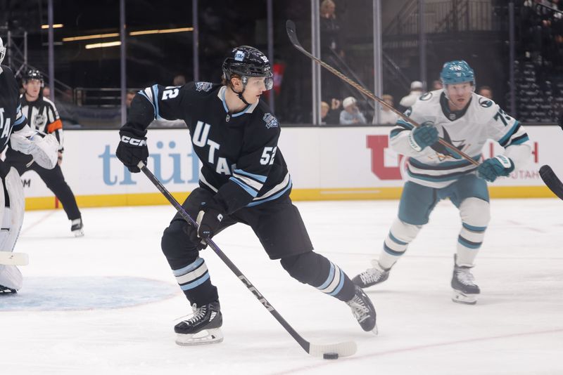 Oct 28, 2024; Salt Lake City, Utah, USA; Utah Hockey Club defenseman Vladislav Kolyachonok (52) controls the puck against the San Jose Sharks at Delta Center. Mandatory Credit: Chris Nicoll-Imagn Images