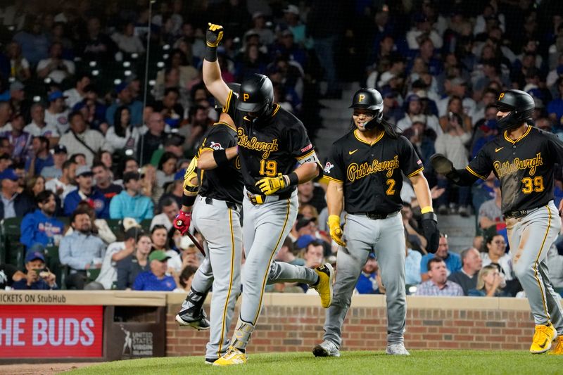 Sep 3, 2024; Chicago, Illinois, USA; Pittsburgh Pirates third baseman Jared Triolo (19) is greeted by teammates after hitting a three-run home run against the Chicago Cubs during the seventh inning at Wrigley Field. Mandatory Credit: David Banks-Imagn Images