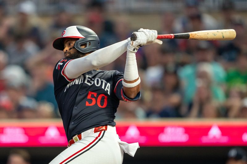 Jul 22, 2024; Minneapolis, Minnesota, USA; Minnesota Twins shortstop Willi Castro (50) hits a RBI single against the Philadelphia Phillies in the third inning at Target Field. Mandatory Credit: Jesse Johnson-USA TODAY Sports