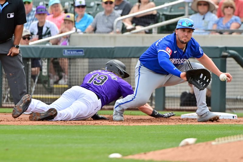 Mar 12, 2024; Salt River Pima-Maricopa, Arizona, USA;  Colorado Rockies designated hitter Charlie Blackmon (19) tags up as Kansas City Royals first baseman Vinnie Pasquantino (9) catches the ball in the first inning during a spring training game at Salt River Fields at Talking Stick. Mandatory Credit: Matt Kartozian-USA TODAY Sports