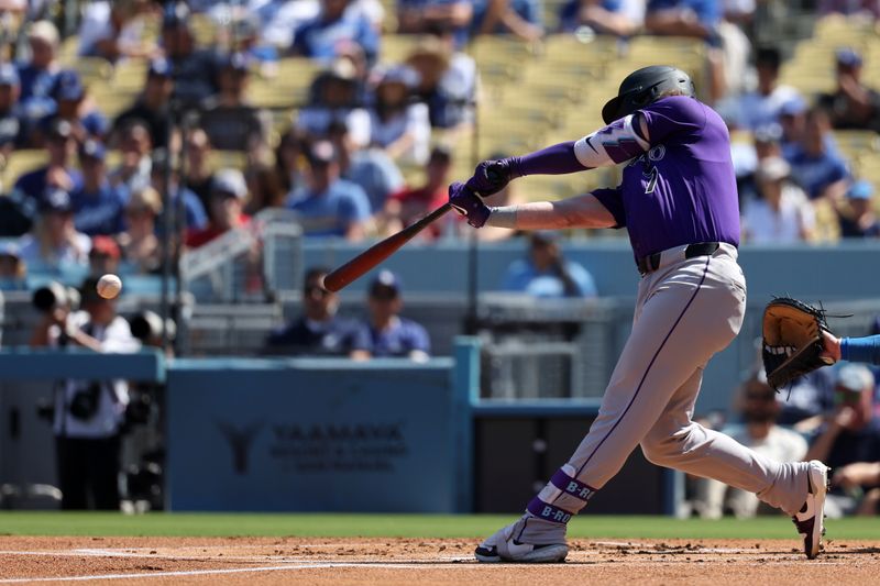 Sep 22, 2024; Los Angeles, California, USA; Colorado Rockies second baseman Brendan Rodgers (7) hits an RBI single during the first inning against the Los Angeles Dodgers at Dodger Stadium. Mandatory Credit: Kiyoshi Mio-Imagn Images