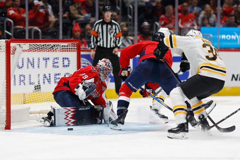 Oct 5, 2024; Washington, District of Columbia, USA; Washington Capitals goaltender Charlie Lindgren (79) makes a save on Boston Bruins center Patrick Brown (38) in the second period at Capital One Arena. Mandatory Credit: Geoff Burke-Imagn Images