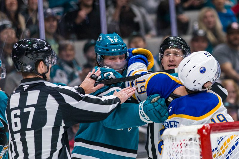 Nov 23, 2024; San Jose, California, USA; San Jose Sharks center Ty Dellandrea (53) and Buffalo Sabres center Peyton Krebs (19) fight during the first period at SAP Center in San Jose. Mandatory Credit: John Hefti-Imagn Images