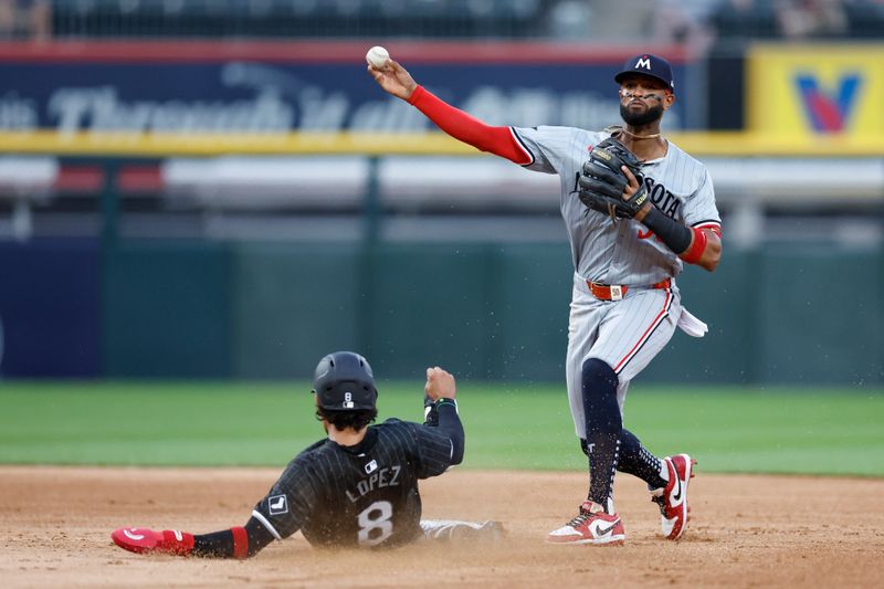 Jul 8, 2024; Chicago, Illinois, USA; Minnesota Twins second baseman Willi Castro (50) throws out Chicago White Sox second baseman Nicky Lopez (8) at second base during the third inning at Guaranteed Rate Field. Mandatory Credit: Kamil Krzaczynski-USA TODAY Sports