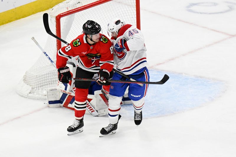 Jan 3, 2025; Chicago, Illinois, USA;  Chicago Blackhawks center Ryan Donato (8) and Montreal Canadiens defenseman Alexandre Carrier (45) dodge the puck during the third period at United Center. Mandatory Credit: Matt Marton-Imagn Images