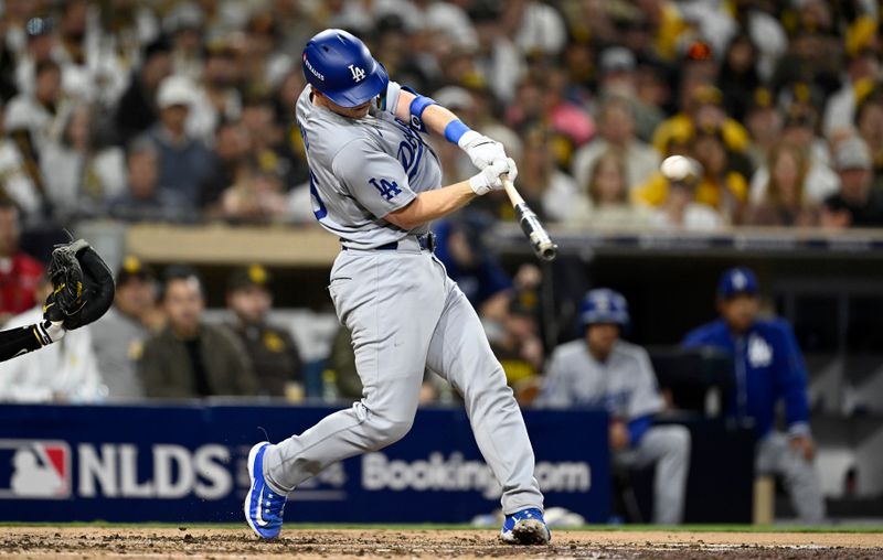 Oct 9, 2024; San Diego, California, USA; Los Angeles Dodgers catcher Will Smith (16) hits a two-run home run in the third inning against the San Diego Padres during game four of the NLDS for the 2024 MLB Playoffs at Petco Park.  Mandatory Credit: Denis Poroy-Imagn Images