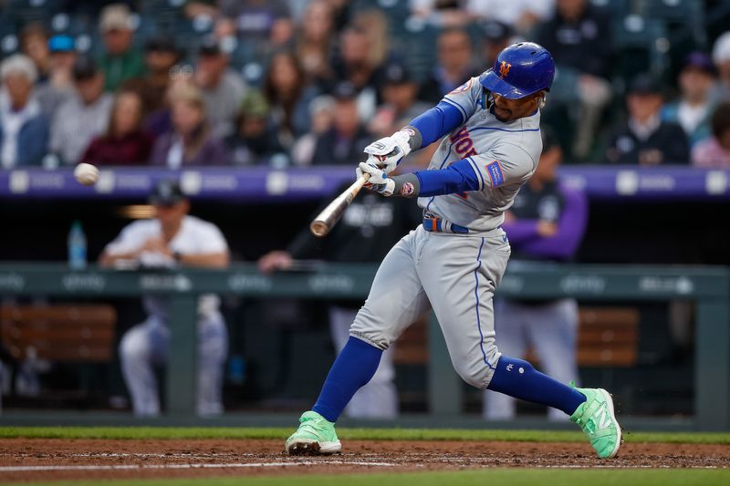 May 26, 2023; Denver, Colorado, USA; New York Mets shortstop Francisco Lindor (12) hits an RBI single in the fifth inning against the Colorado Rockies at Coors Field. Mandatory Credit: Isaiah J. Downing-USA TODAY Sports