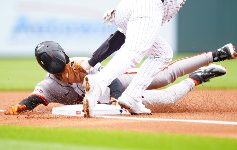 May 9, 2024; Denver, Colorado, USA; Colorado Rockies third base Ryan McMahon tags out San Francisco Giants second base Thairo Estrada on a steal attempt in the first inning against the Colorado Rockies at Coors Field. Mandatory Credit: Ron Chenoy-USA TODAY Sports