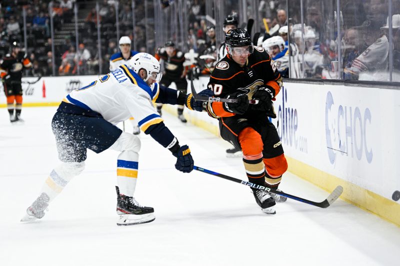 Mar 25, 2023; Anaheim, California, USA; St. Louis Blues defenseman Marco Scandella (6) reaches for the puck against Anaheim Ducks defenseman Nathan Beaulieu (28) during first period at Honda Center. Mandatory Credit: Kelvin Kuo-USA TODAY Sports