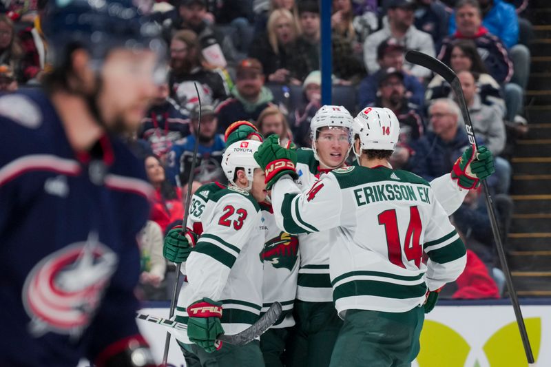 Jan 6, 2024; Columbus, Ohio, USA;  Minnesota Wild left wing Matt Boldy (12) celebrates with teammates after scoring a goal against the Columbus Blue Jackets in the second period at Nationwide Arena. Mandatory Credit: Aaron Doster-USA TODAY Sports