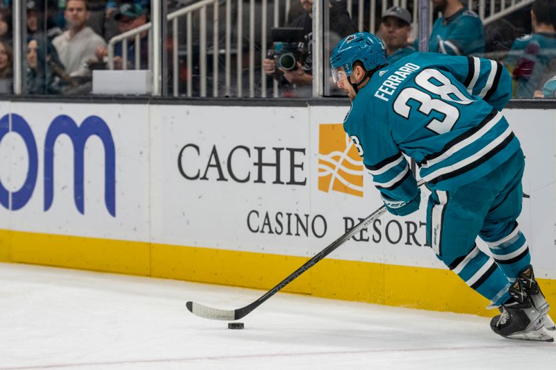 Dec 19, 2023; San Jose, California, USA; San Jose Sharks defenseman Mario Ferraro (38) controls the puck behind the net against the Los Angeles Kings during the first period at SAP Center at San Jose. Mandatory Credit: Neville E. Guard-USA TODAY Sports