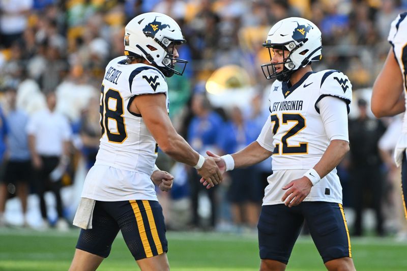 Sep 14, 2024; Pittsburgh, Pennsylvania, USA; West Virginia Mountaineers place kicker Michael Hayes II (22) celebrates with Leighton Bechdel (98) after a field goal against the Pittsburgh Panthers during the second quarter at Acrisure Stadium. Mandatory Credit: Barry Reeger-Imagn Images