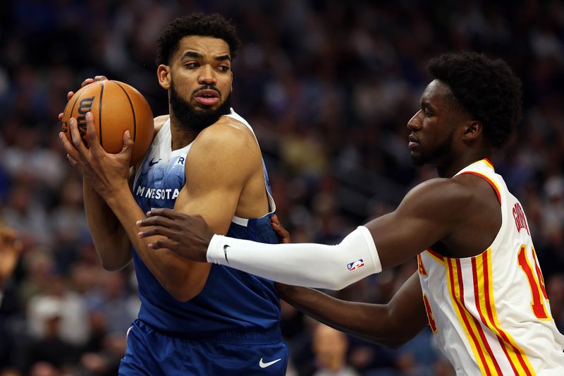 MINNEAPOLIS, MINNESOTA - APRIL 12: Karl-Anthony Towns #32 of the Minnesota Timberwolves steals the ball from AJ Griffin #14 of the Atlanta Hawks in the first quarter at Target Center on April 12, 2024 in Minneapolis, Minnesota. NOTE TO USER: User expressly acknowledges and agrees that, by downloading and or using this photograph, User is consenting to the terms and conditions of the Getty Images License Agreement. (Photo by David Berding/Getty Images)