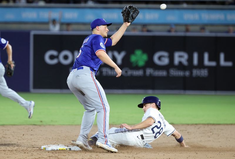Jun 4, 2025; St. Petersburg, Florida, USA;  Tampa Bay Rays outfielder Jake Mangum (28) steals second base as Texas Rangers shortstop Corey Seager (5) attempted to tag him out during the third inning at George M. Steinbrenner Field. Mandatory Credit: Kim Klement Neitzel-Imagn Images
