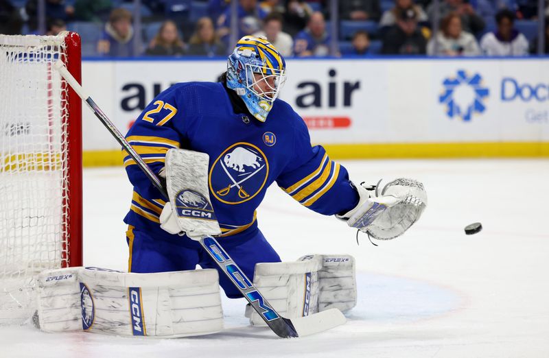 Jan 9, 2024; Buffalo, New York, USA;  Buffalo Sabres goaltender Devon Levi (27) looks to make a save during the first period against the Seattle Kraken at KeyBank Center. Mandatory Credit: Timothy T. Ludwig-USA TODAY Sports