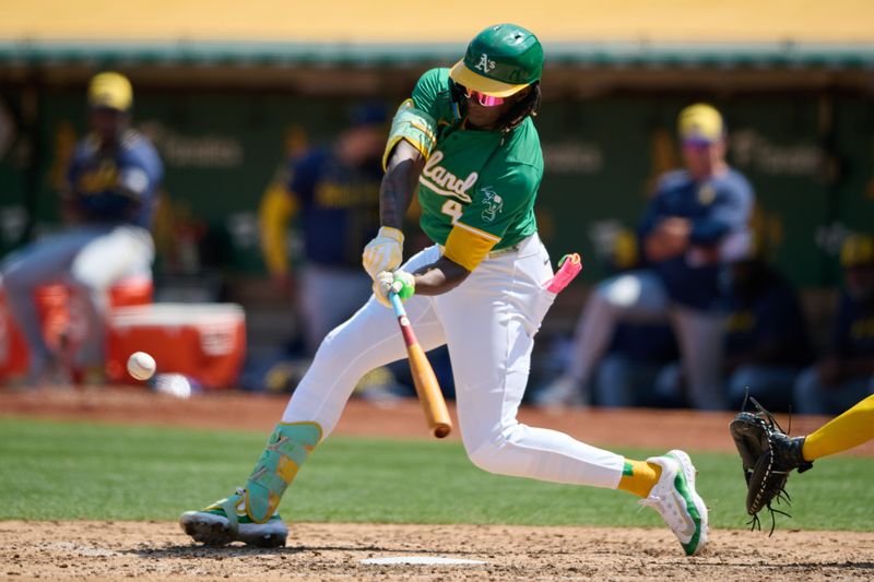 Aug 24, 2024; Oakland, California, USA; Oakland Athletics outfielder Lawrence Butler (4) hits a single against the Milwaukee Brewers during the sixth inning at Oakland-Alameda County Coliseum. Mandatory Credit: Robert Edwards-USA TODAY Sports