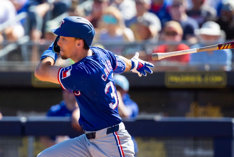 Mar 5, 2024; Peoria, Arizona, USA; Texas Rangers outfielder Evan Carter hits a home run against the Seattle Mariners during a spring training baseball game at Peoria Sports Complex. Mandatory Credit: Mark J. Rebilas-USA TODAY Sports