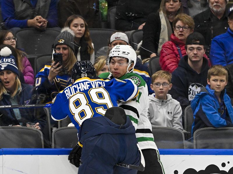 Dec 27, 2023; St. Louis, Missouri, USA;  St. Louis Blues left wing Pavel Buchnevich (89) checks Dallas Stars left wing Jason Robertson (21) during the first period at Enterprise Center. Mandatory Credit: Jeff Curry-USA TODAY Sports