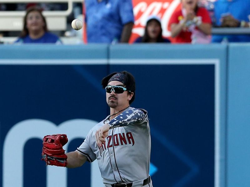 Jul 4, 2024; Los Angeles, California, USA; Arizona Diamondbacks outfielder Corbin Carroll (7) throws to the infield during the second inning against the Los Angeles Dodgers at Dodger Stadium. Mandatory Credit: Jason Parkhurst-USA TODAY Sports