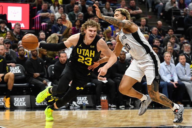 SALT LAKE CITY, UTAH - MARCH 27: Lauri Markkanen #23 of the Utah Jazz drives into Jeremy Sochan #10 of the San Antonio Spurs during the second half of a game at Delta Center on March 27, 2024 in Salt Lake City, Utah. NOTE TO USER: User expressly acknowledges and agrees that, by downloading and or using this photograph, User is consenting to the terms and conditions of the Getty Images License Agreement. (Photo by Alex Goodlett/Getty Images)